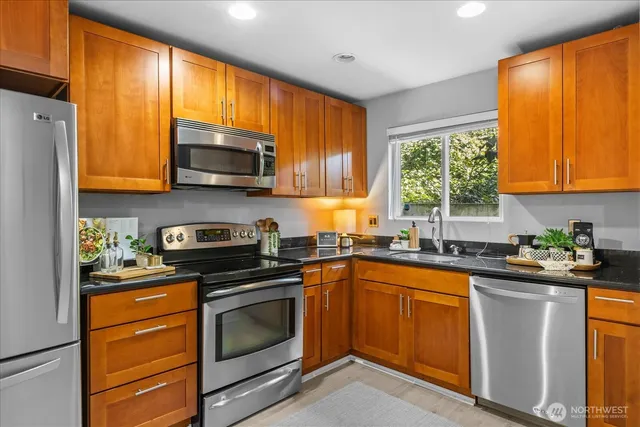 a kitchen with a sink a stove and cabinets