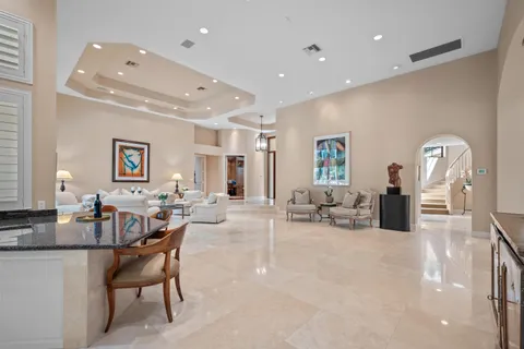 a view of a dining room with furniture a chandelier and wooden floor