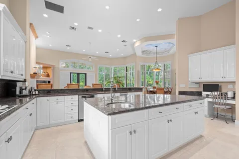 a dining room with furniture a chandelier and window