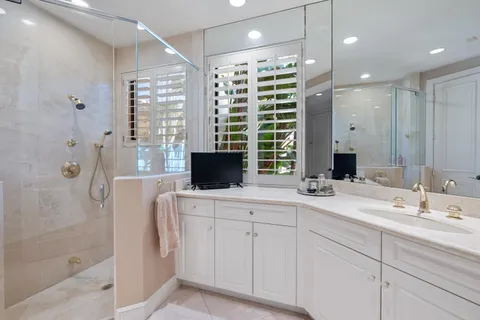 a bathroom with a granite countertop sink a toilet a tub and shower