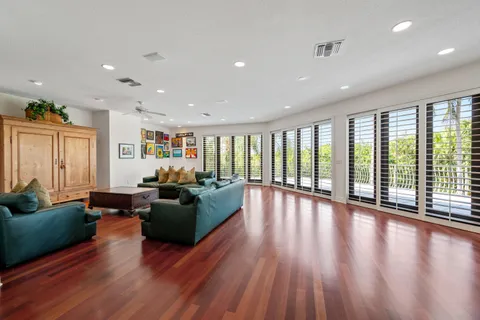 a view of a house with swimming pool and sitting area