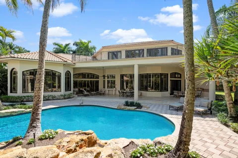 a kitchen with white cabinets and sink