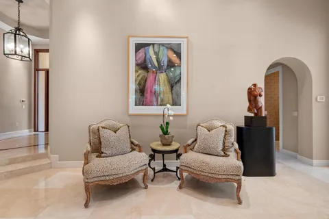 a dining hall with stainless steel appliances granite countertop a dining table and chairs