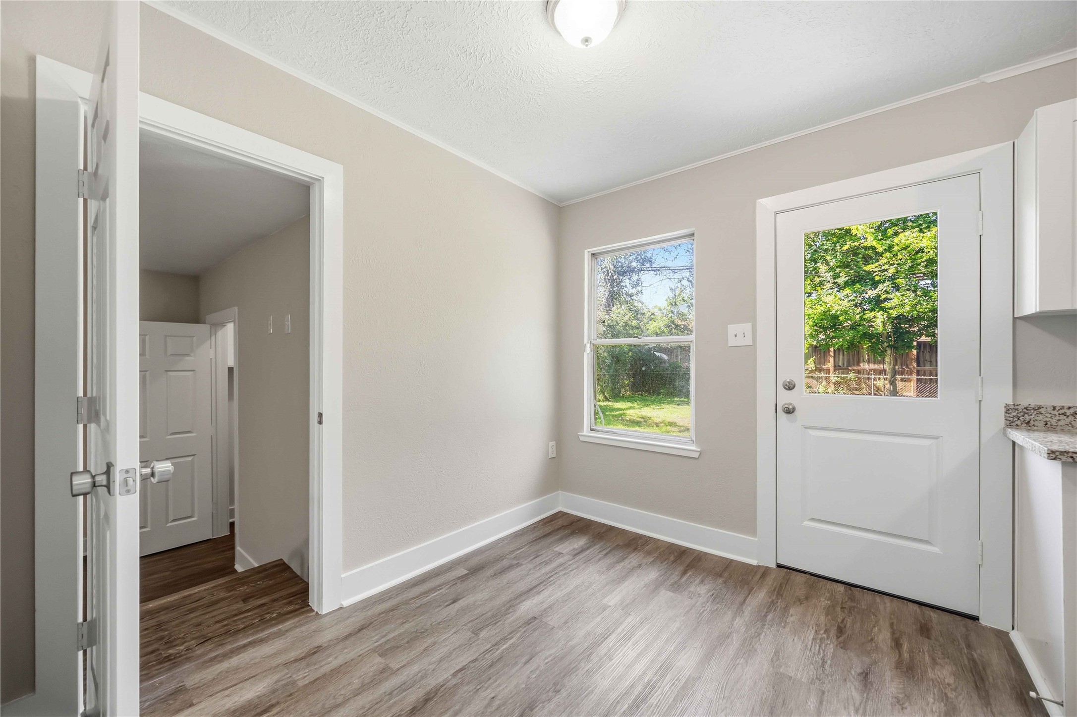 113 East Witcher Lane Houston, TX 77076 - Photo 9 of 21 an empty room with wooden floor and a window