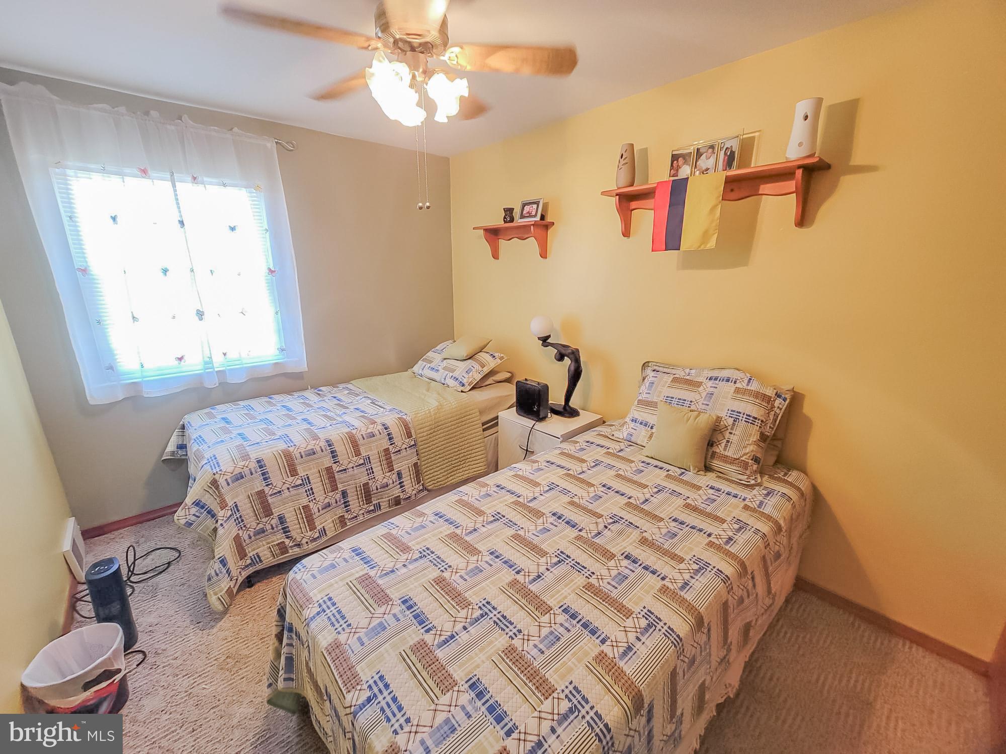 12628 Richton Road Philadelphia, PA 19154 - Photo 2 of 12 a bedroom with two beds and a large mirror
