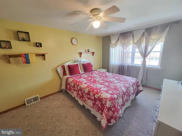 a bedroom with a bed and window