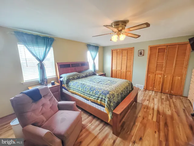 a bedroom with a large bed and a window