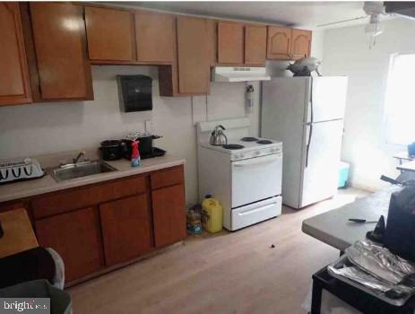 2821 West 3rd Street Chester, PA 19013 - Photo 3 of 9 a kitchen with stainless steel appliances granite countertop a refrigerator sink and cabinets