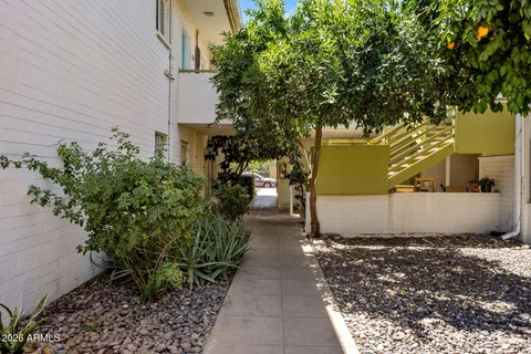 a view of a house with backyard porch and sitting area
