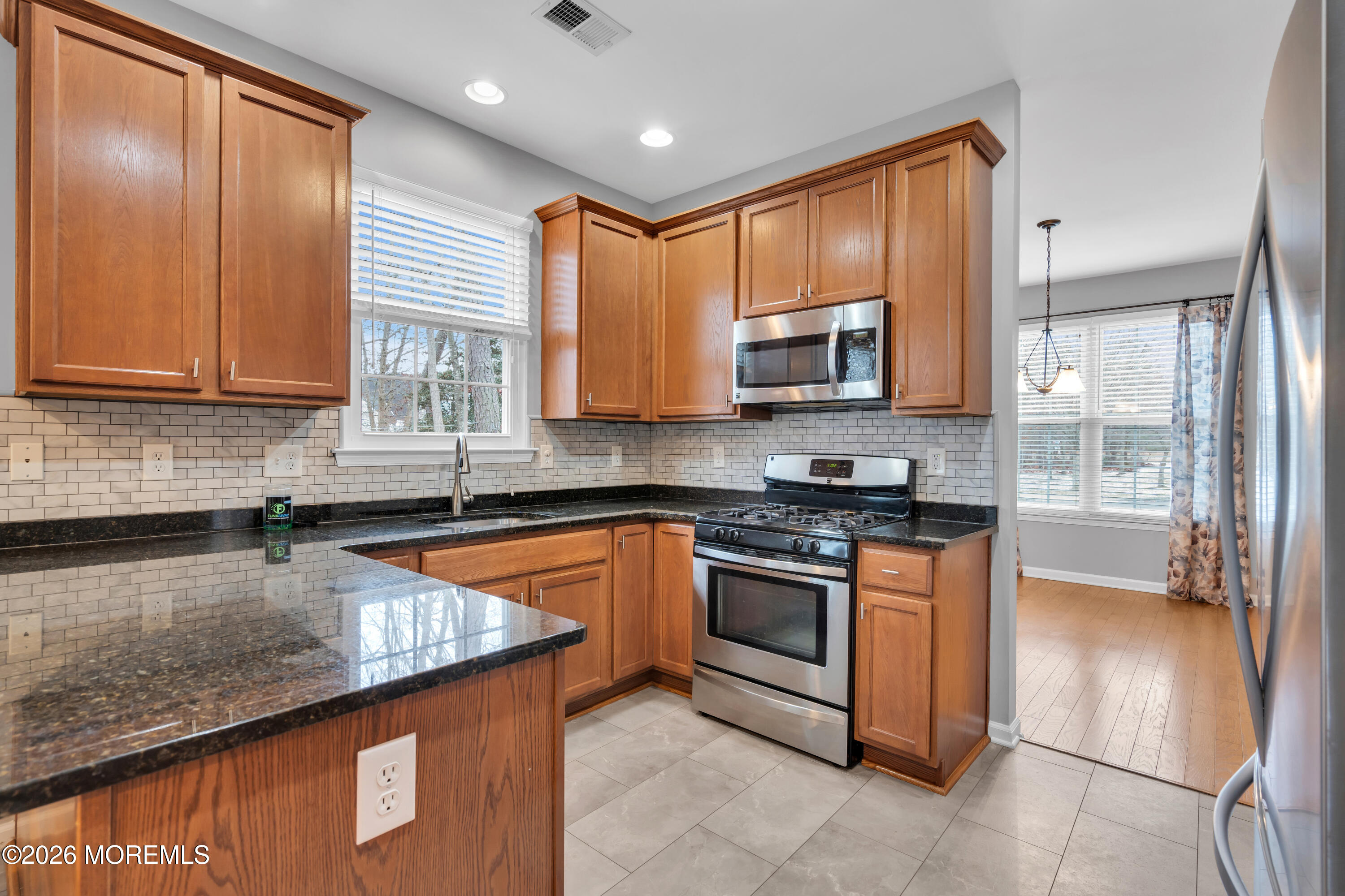 2 Daffodil Drive Little Egg Harbor, NJ 08087 - Photo 2 of 37 a kitchen with stainless steel appliances granite countertop wooden cabinets a stove top oven a sink and dishwasher