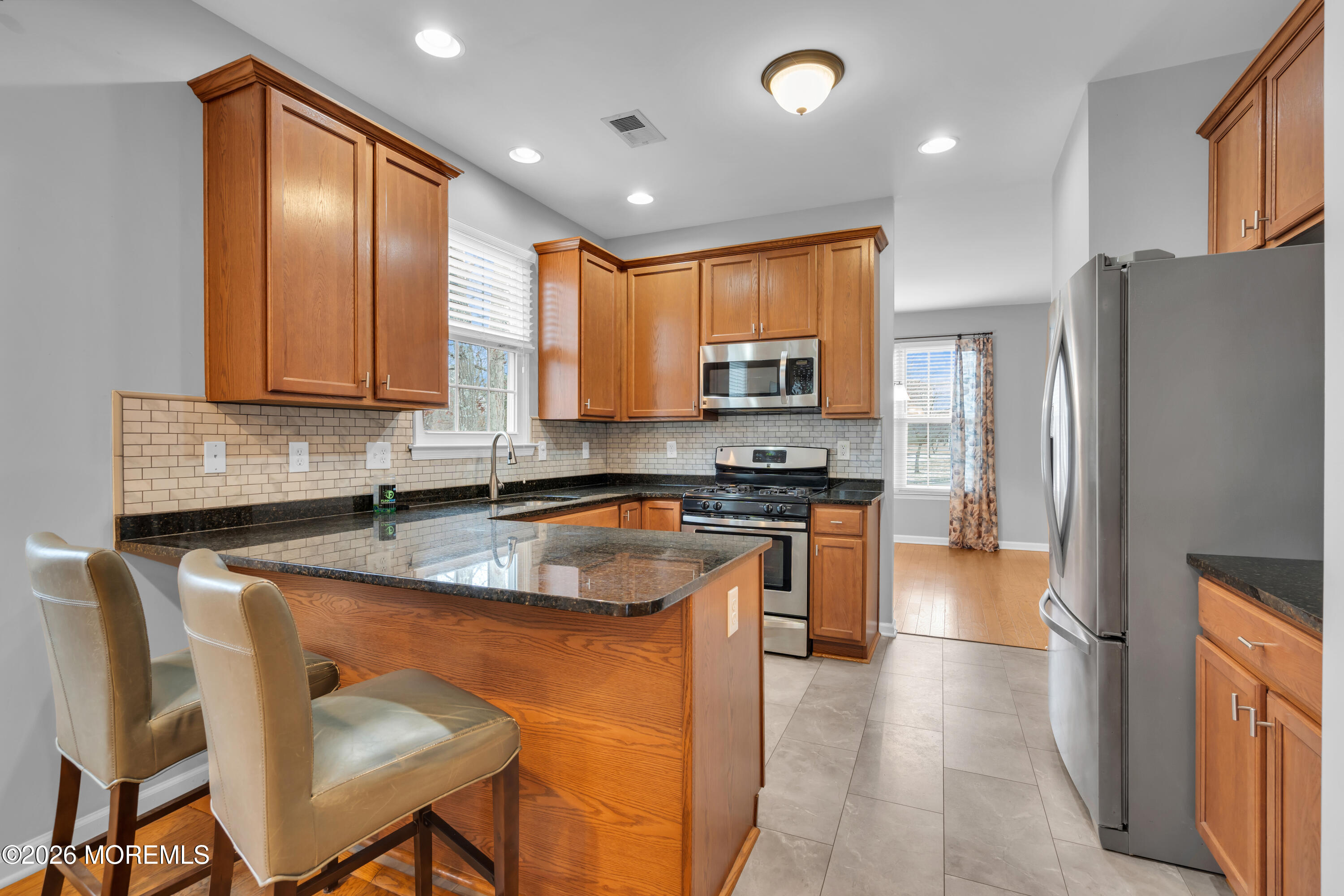 2 Daffodil Drive Little Egg Harbor, NJ 08087 - Photo 25 of 37 a kitchen with stainless steel appliances granite countertop a stove top oven a refrigerator a sink and a dining table