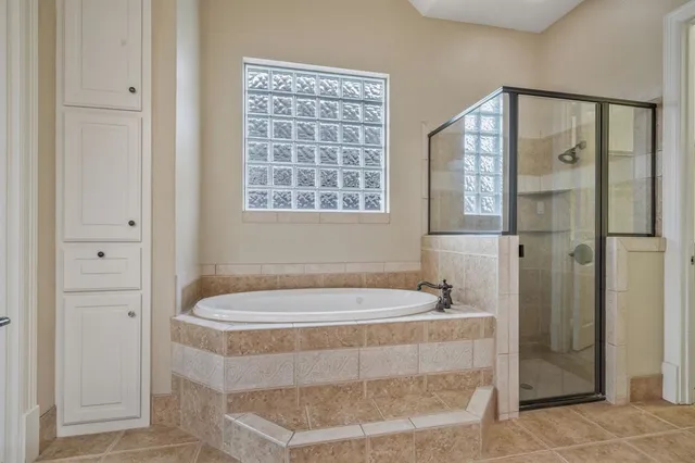 a bathroom with a bathtub and shower