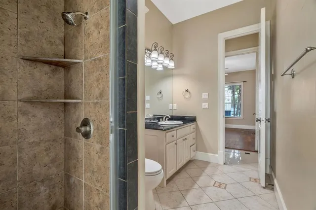 a large tree in front of a house next to a yard