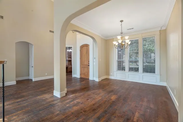 a view of a big room with wooden floor chandelier and livingroom