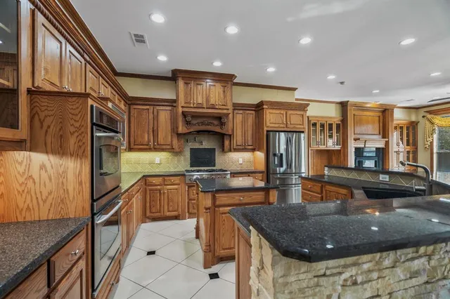 a kitchen with stainless steel appliances granite countertop sink microwave and stove