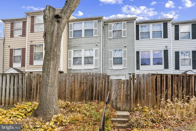 a view of a brick house with many windows