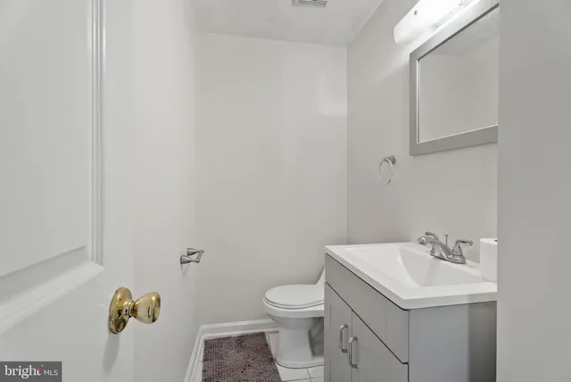 a bathroom with a sink toilet and vanity
