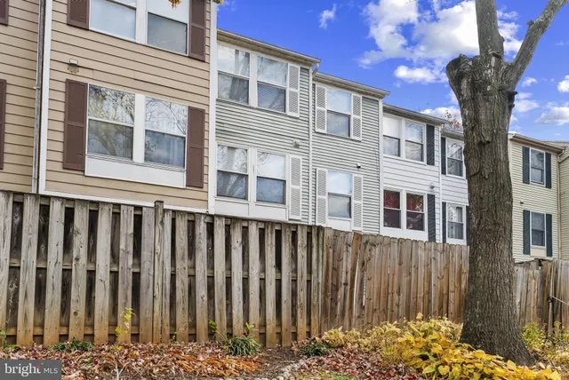 a front view of a house with a tree