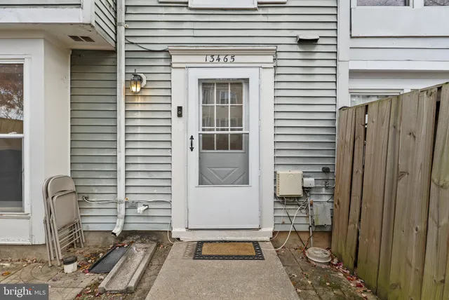 a view of backyard with a chair and the door