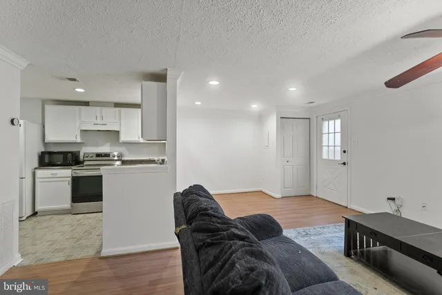 a living room with furniture and kitchen