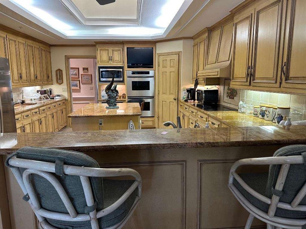 5321 Bent Tree Drive Dallas, TX 75248 - Photo 2 of 9 a kitchen with a table chairs sink and cabinets