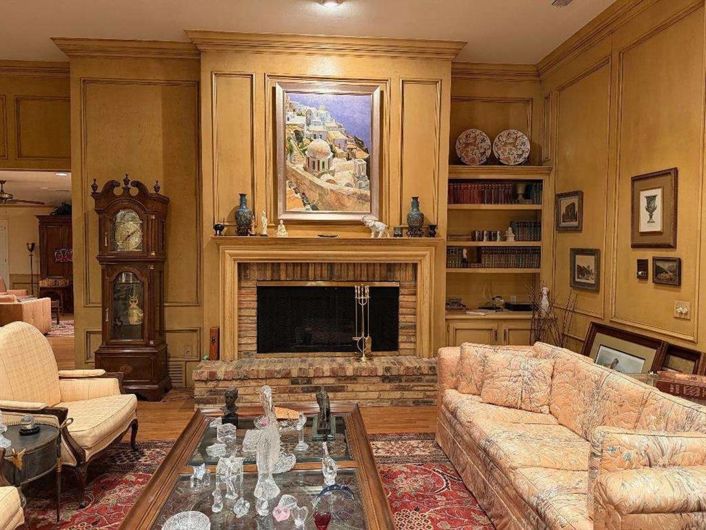 5321 Bent Tree Drive Dallas, TX 75248 - Photo 4 of 9 a living room with furniture a rug and a fireplace