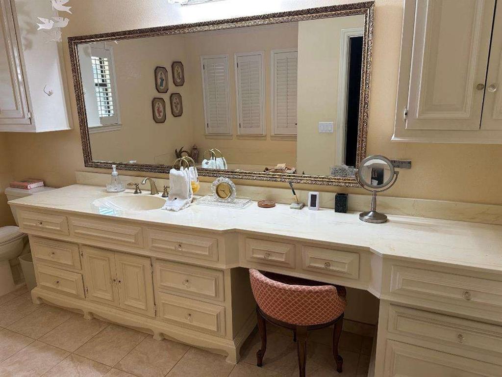 5321 Bent Tree Drive Dallas, TX 75248 - Photo 7 of 9 a bathroom with a sink and a mirror