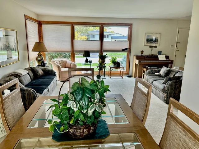 a living room with furniture and a floor to ceiling window
