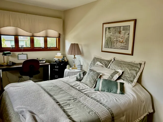 a bedroom with a bed and a chandelier