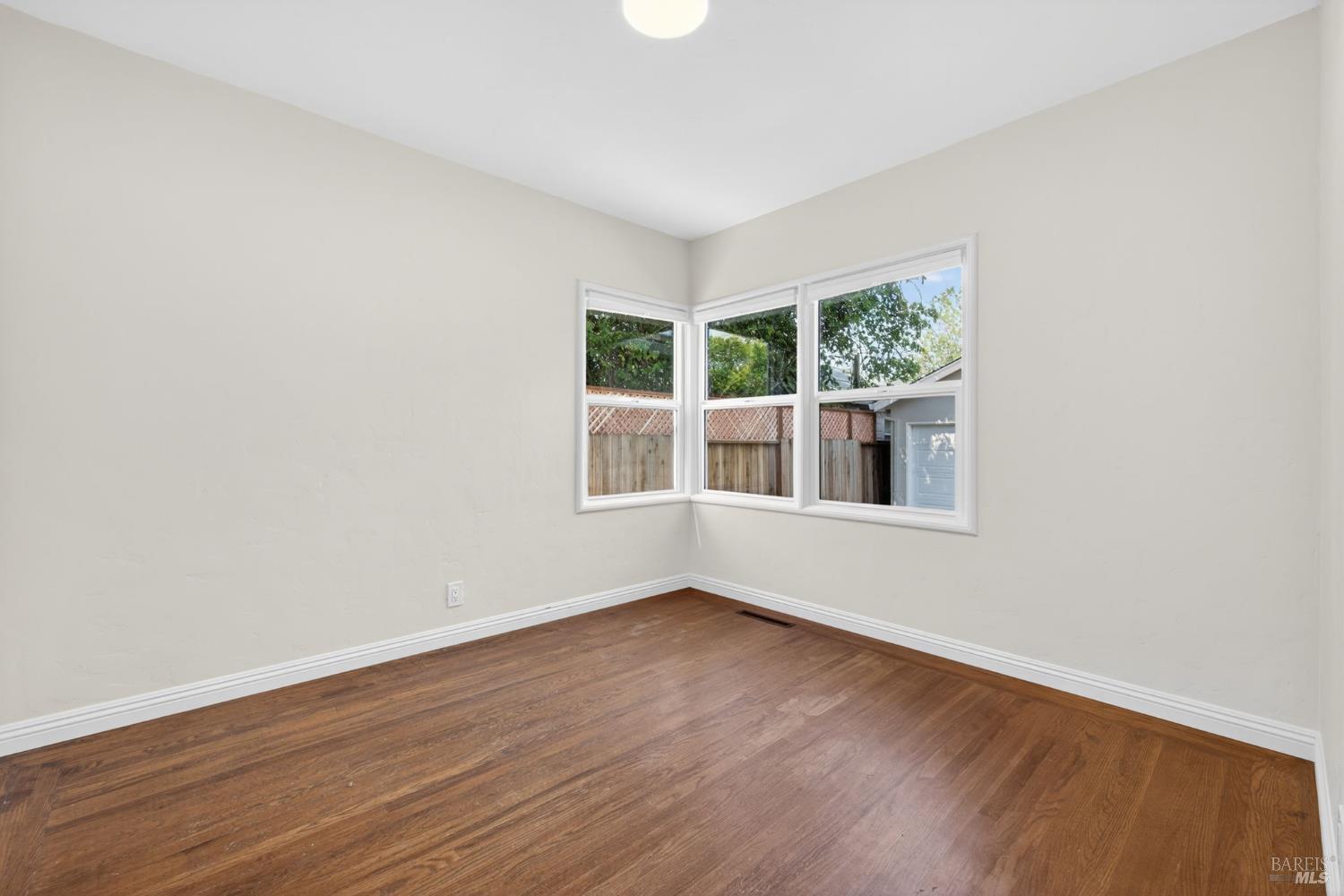 2211 Humboldt Street Santa Rosa, CA 95404 - Photo 24 of 52 an empty room with wooden floor and windows