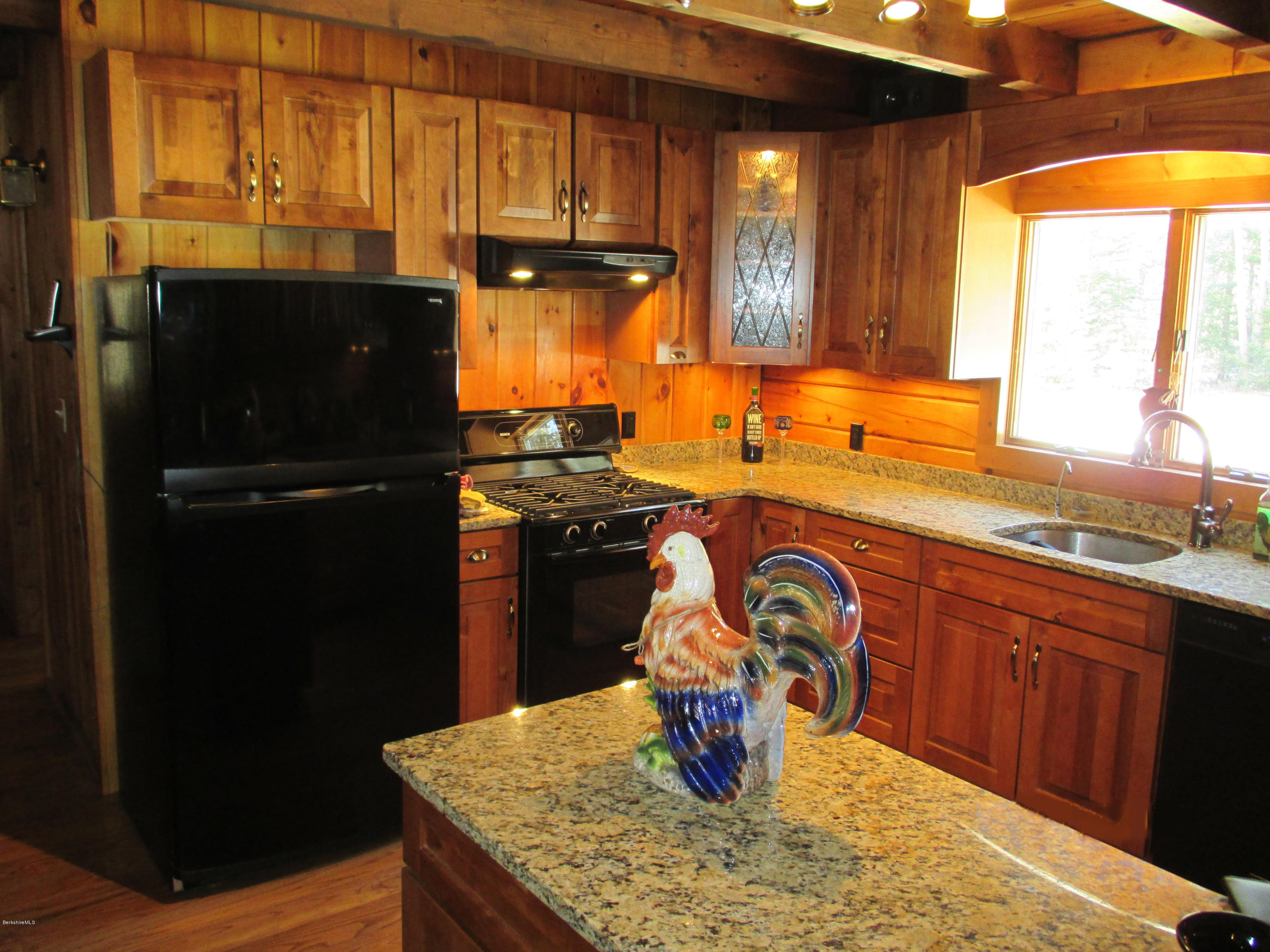 46 West Main Road Peru, MA 01235 - Photo 8 of 29 a kitchen with a sink a stove and black wooden cabinets