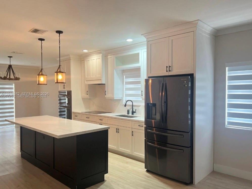 897 East 20th Street Hialeah, FL 33013 - Photo 5 of 13 a kitchen with a refrigerator sink and cabinets