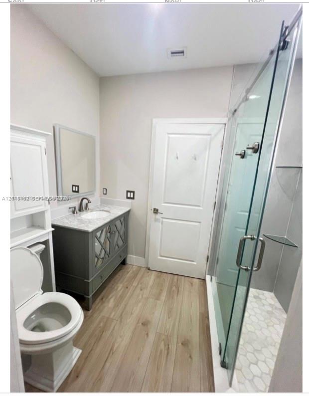 897 East 20th Street Hialeah, FL 33013 - Photo 10 of 13 a bathroom with a sink a toilet and a mirror