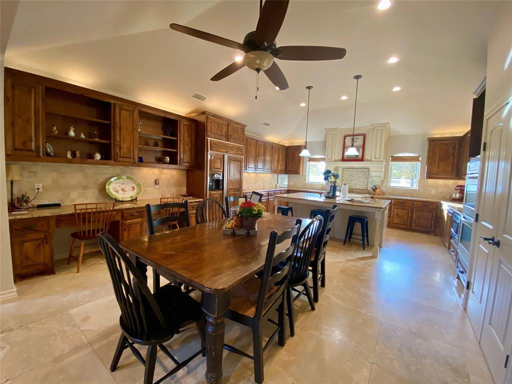 a large kitchen with a table and chairs