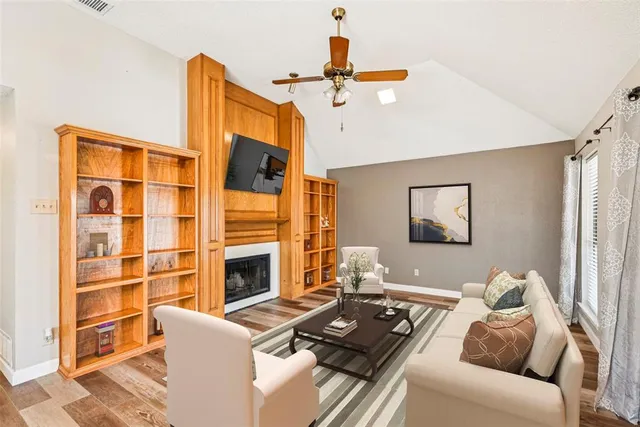 a living room with furniture fireplace and flat screen tv