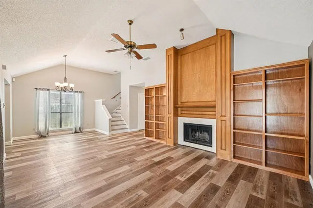 a view of an empty room with a fireplace and a window
