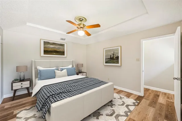 a bedroom with a bed and painting on the wall