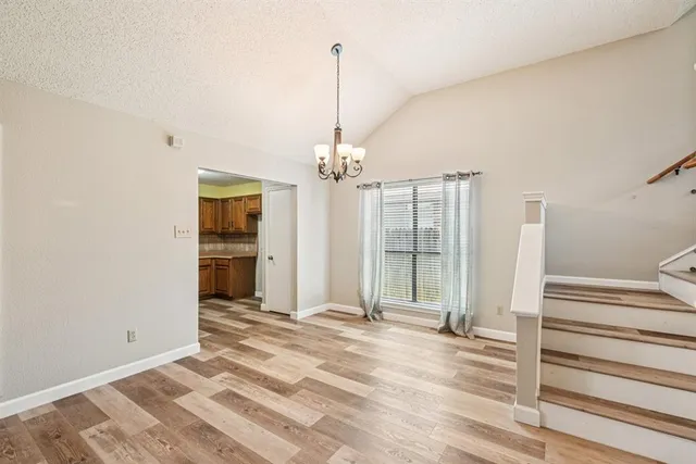 a view of a room with wooden floor and window