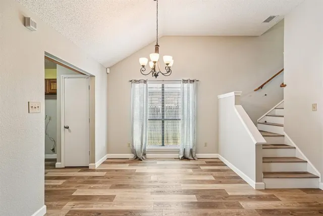 a view of a livingroom with wooden floor and entryway