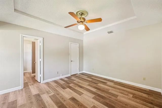 a view of empty room with ceiling fan