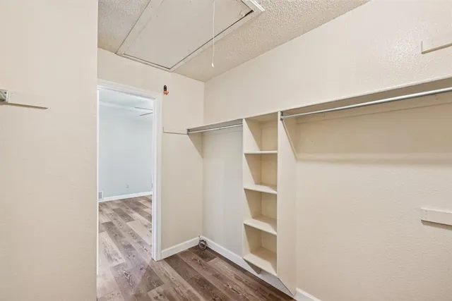 a view of walk in closet with empty racks