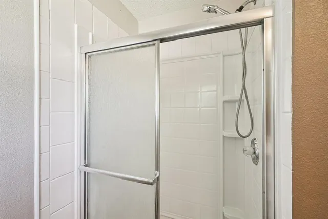 a bathroom with a glass shower door