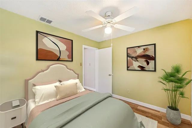 a bedroom with a bed and painting on the wall