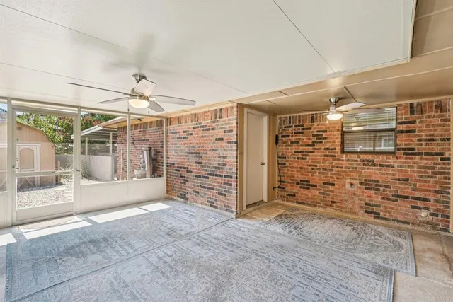 a view of a livingroom with an empty space and the windows