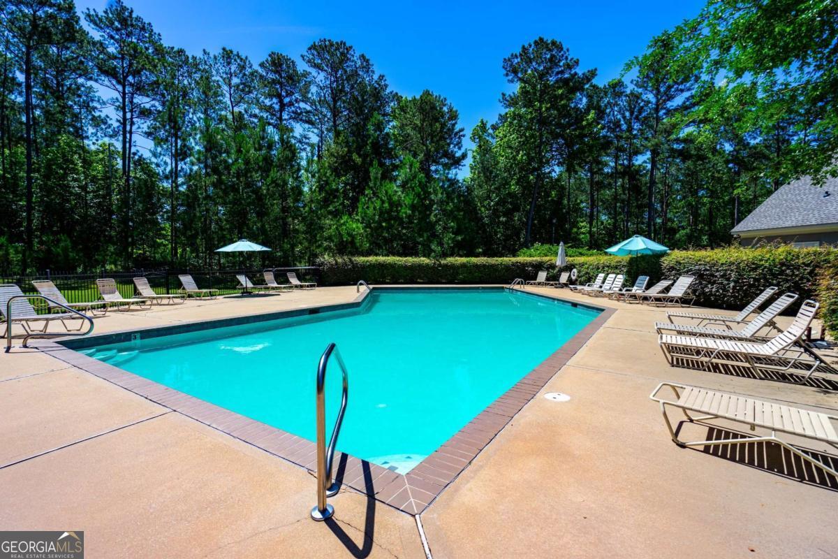 0 Cameron Mill Road LaGrange, GA 30240 - Photo 19 of 28 a view of a swimming pool with lawn chairs under an umbrella