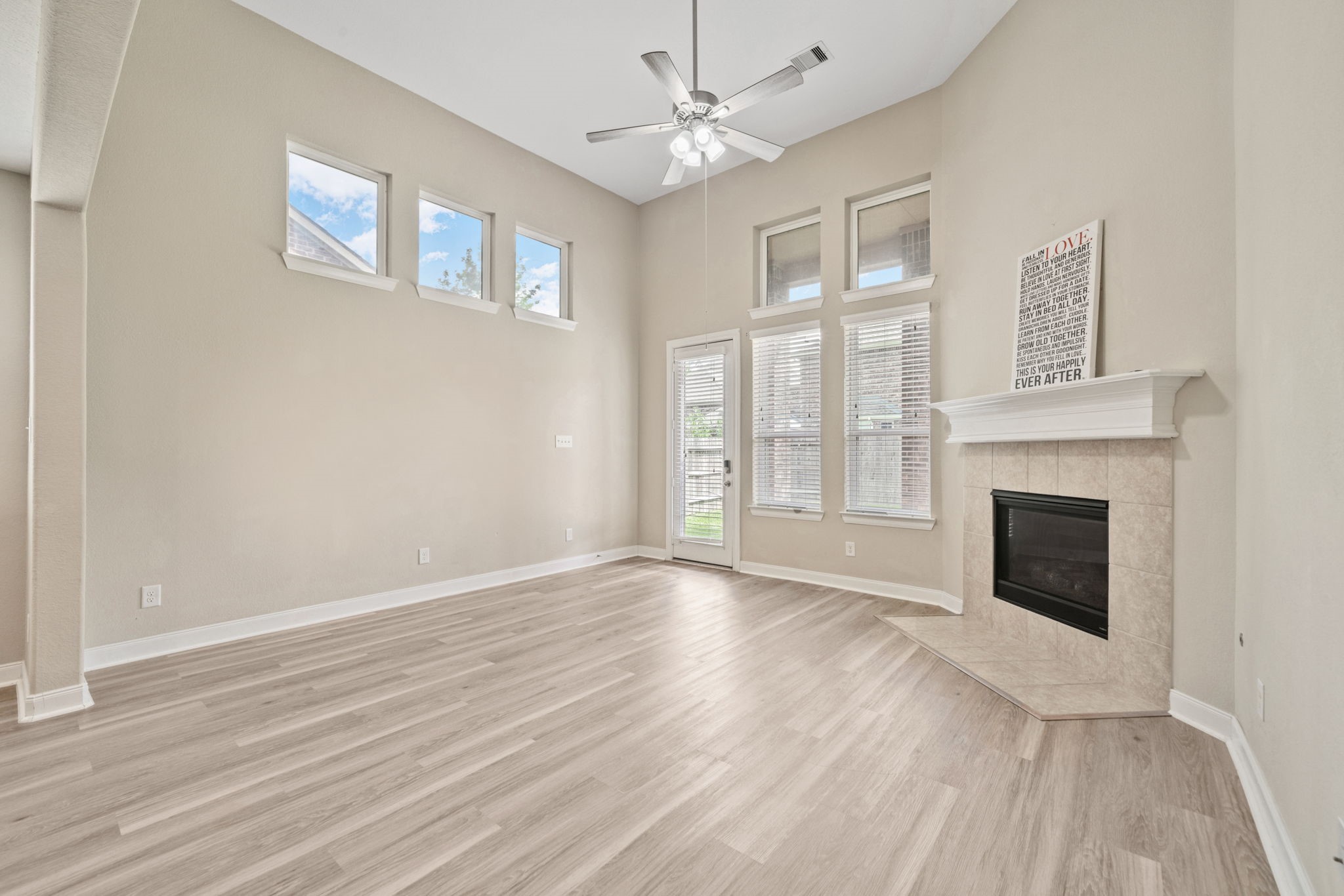 22523 Birch Ridge Meadow Drive Spring, TX 77389 - Photo 8 of 39 a view of an empty room with wooden floor fireplace and a window