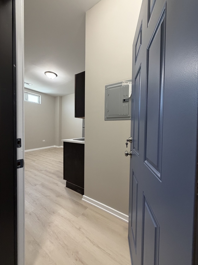 24 North Pulaski Road, Unit 1F Chicago, IL 60624 - Photo 2 of 10 a view of a hallway with wooden floor and staircase