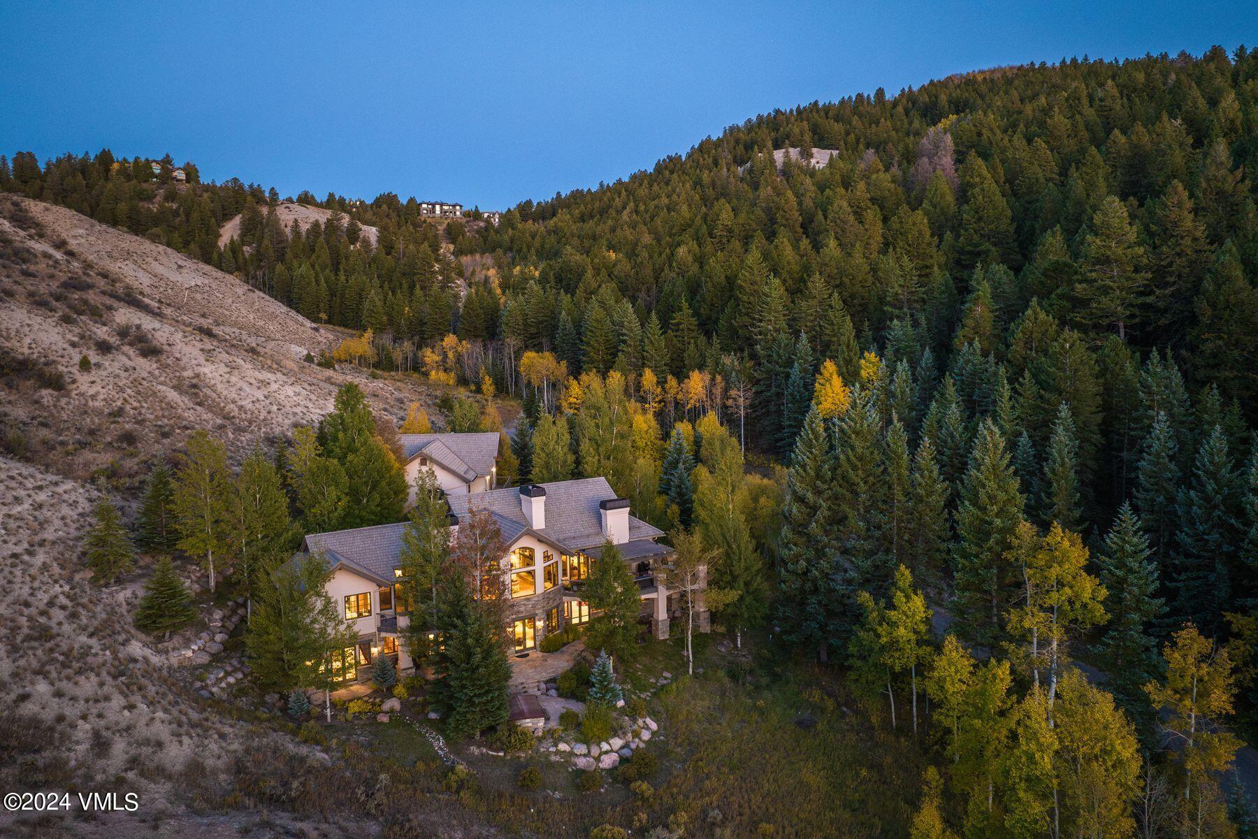 a view of a house with a yard and mountain view