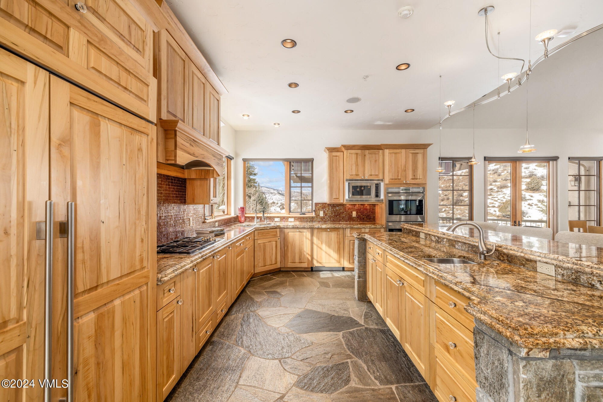 319 Granada Glen Road Edwards, CO 81632 - Photo 13 of 43 a large kitchen with stainless steel appliances lots of counter space and windows