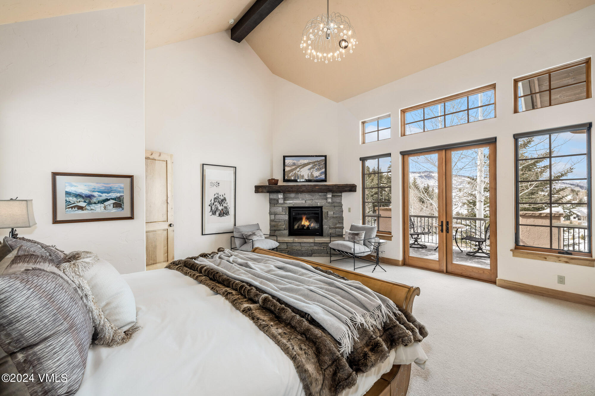 319 Granada Glen Road Edwards, CO 81632 - Photo 19 of 43 a bedroom with a large bed and a fireplace